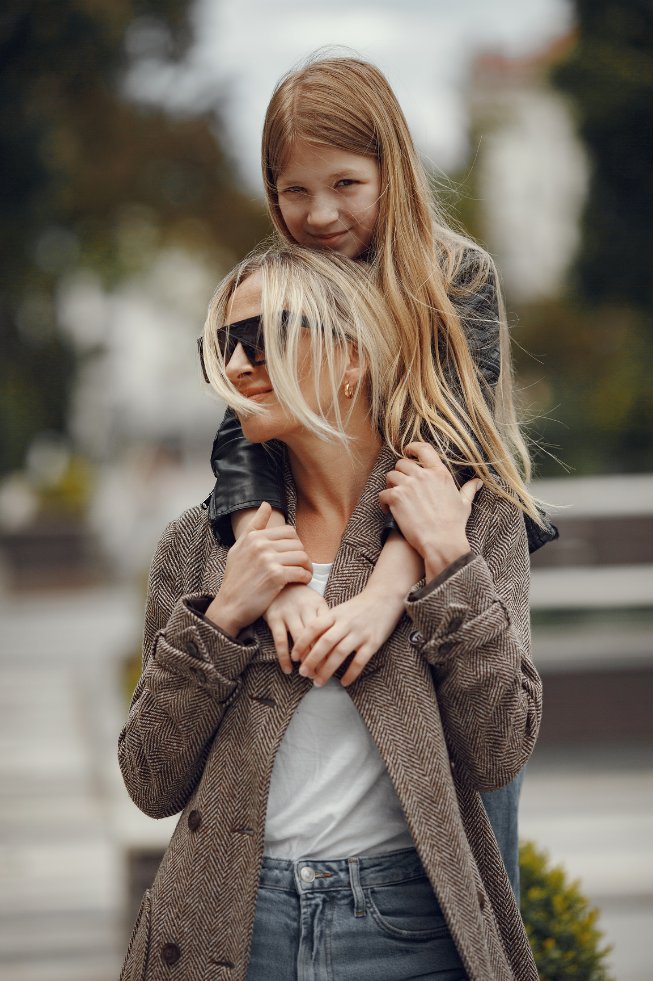 Woman in her 50s looking confident outdoors, smiling freely