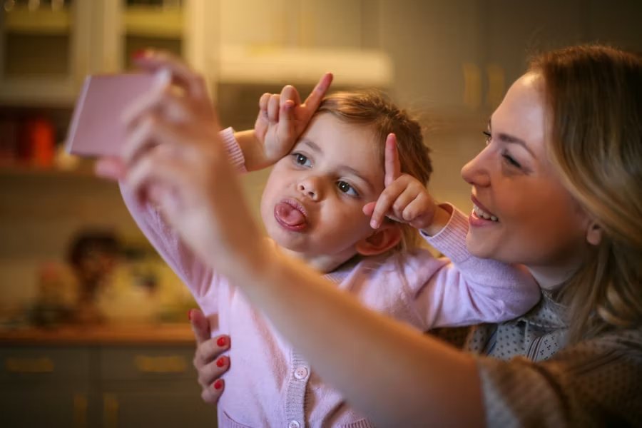 Woman walking outside, holding phone up speaking into it