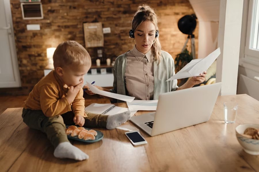 Mom and babysitter sitting together going over a checklist